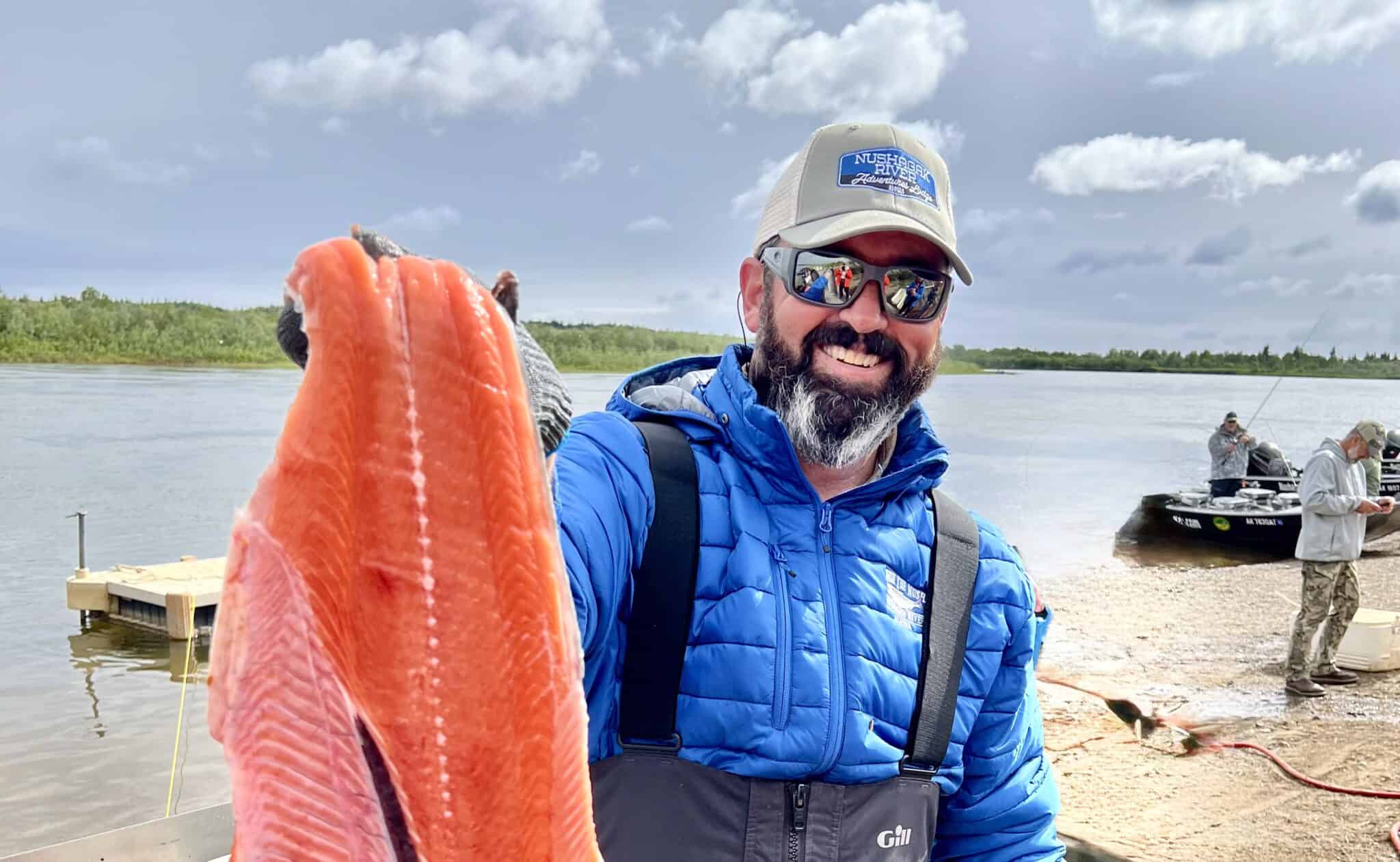 Home Guide Joaquin Capelle with a salmon fillet on the Nushagak